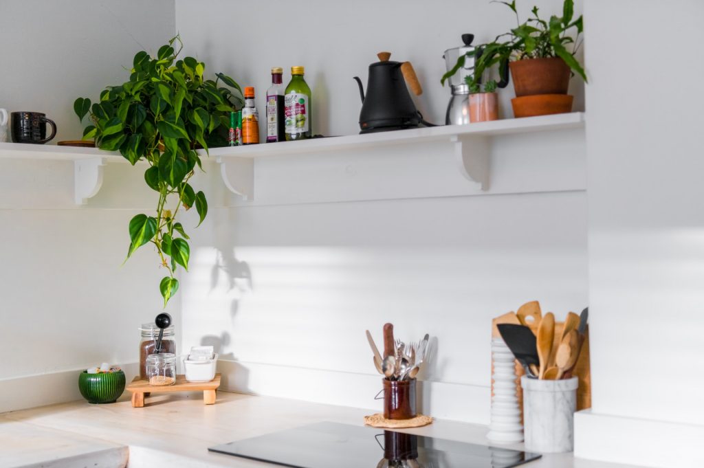 A minimalist kitchen with neatly organized cabinets and countertops, showcasing a clean and clutter-free space.