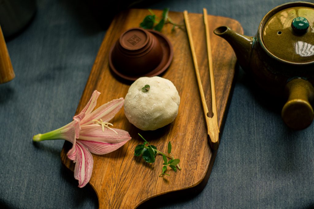 The meticulous art of matcha and mochi preparation: Skillful hands whisk matcha powder into a frothy elixir, while nearby, a tray of perfectly crafted mochis awaits indulgence. Experience the captivating ritual and delectable results of preparing matcha and mochis.