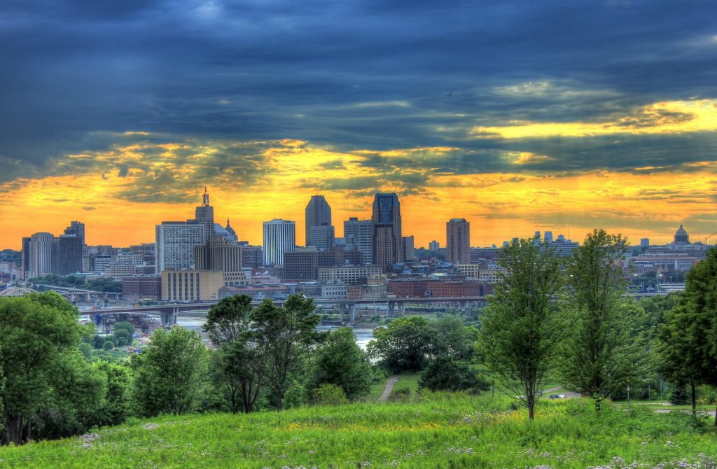 Minneapolis City Park on a sunny day with the city skyline in the background. By Solange Isaacs.