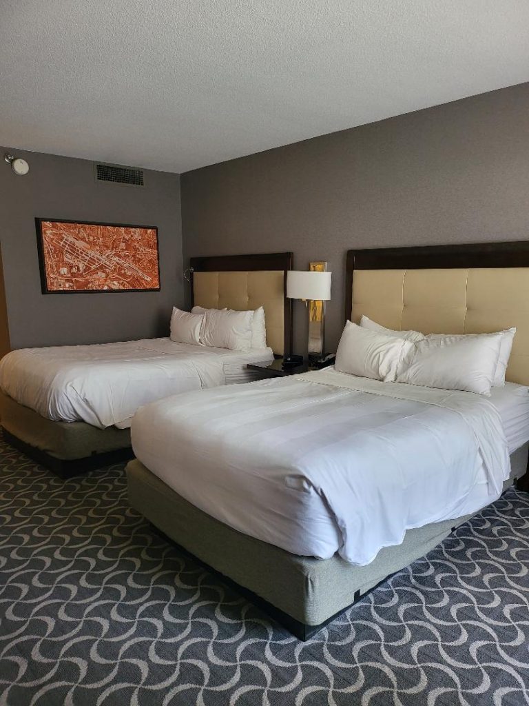 Tranquil bedroom at Marriott St. Louis hotel, featuring plush bedding and a soothing ambiance. Here, There, And Everywhere.