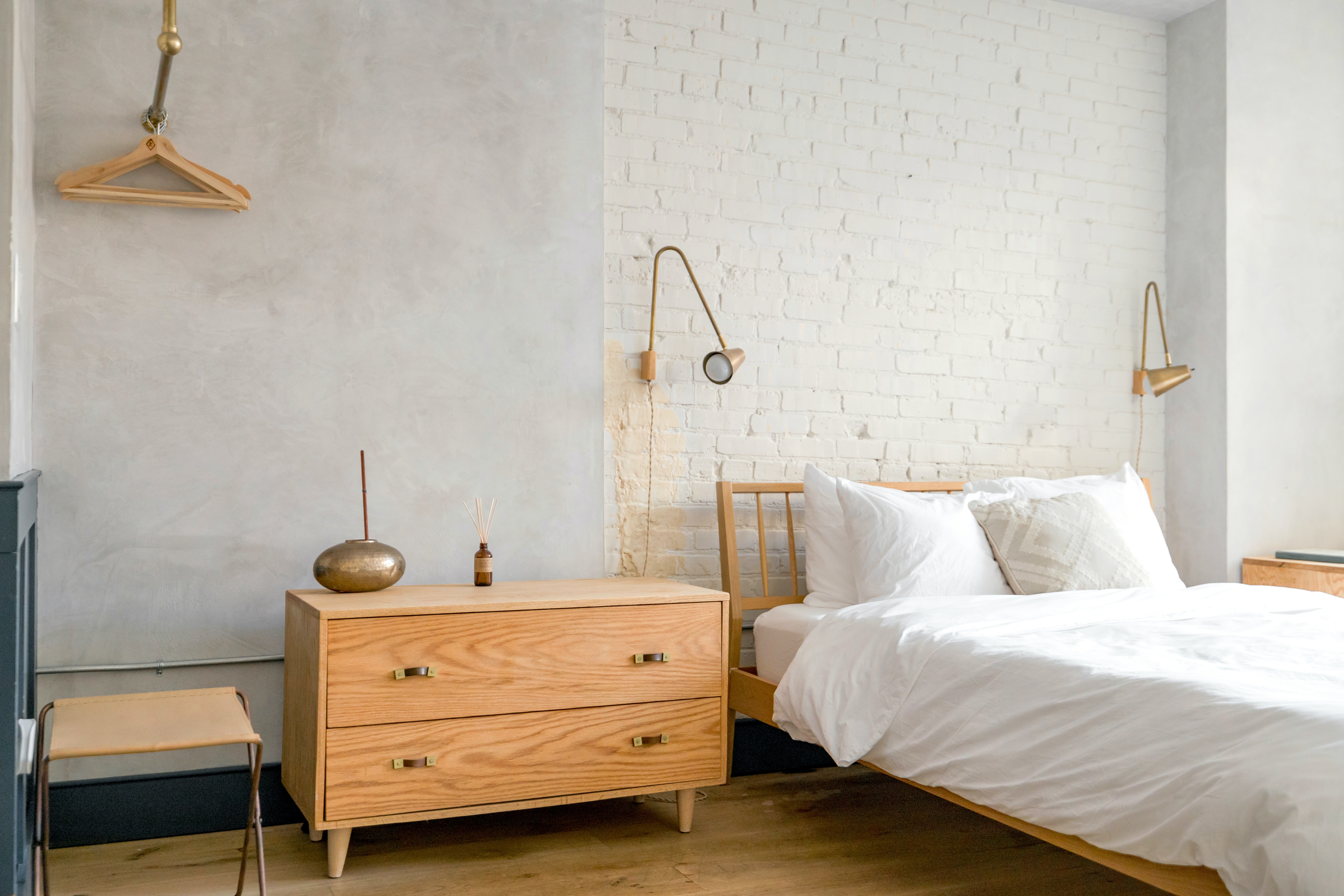 A minimalist bedroom with a clean, uncluttered design, featuring a simple bed, minimalist decor, and organized storage.