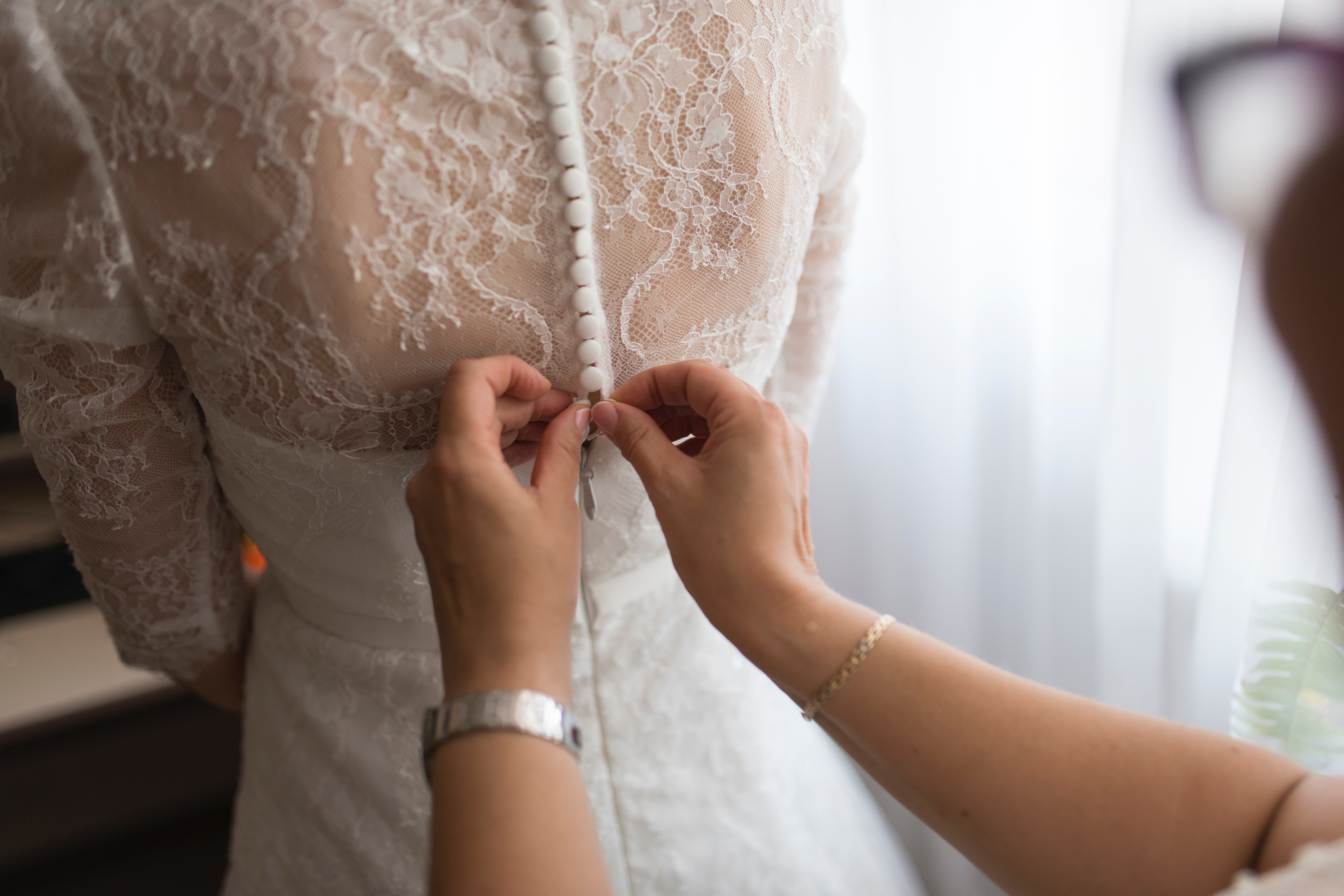 A beautiful wedding dress adorned with lace and intricate details.