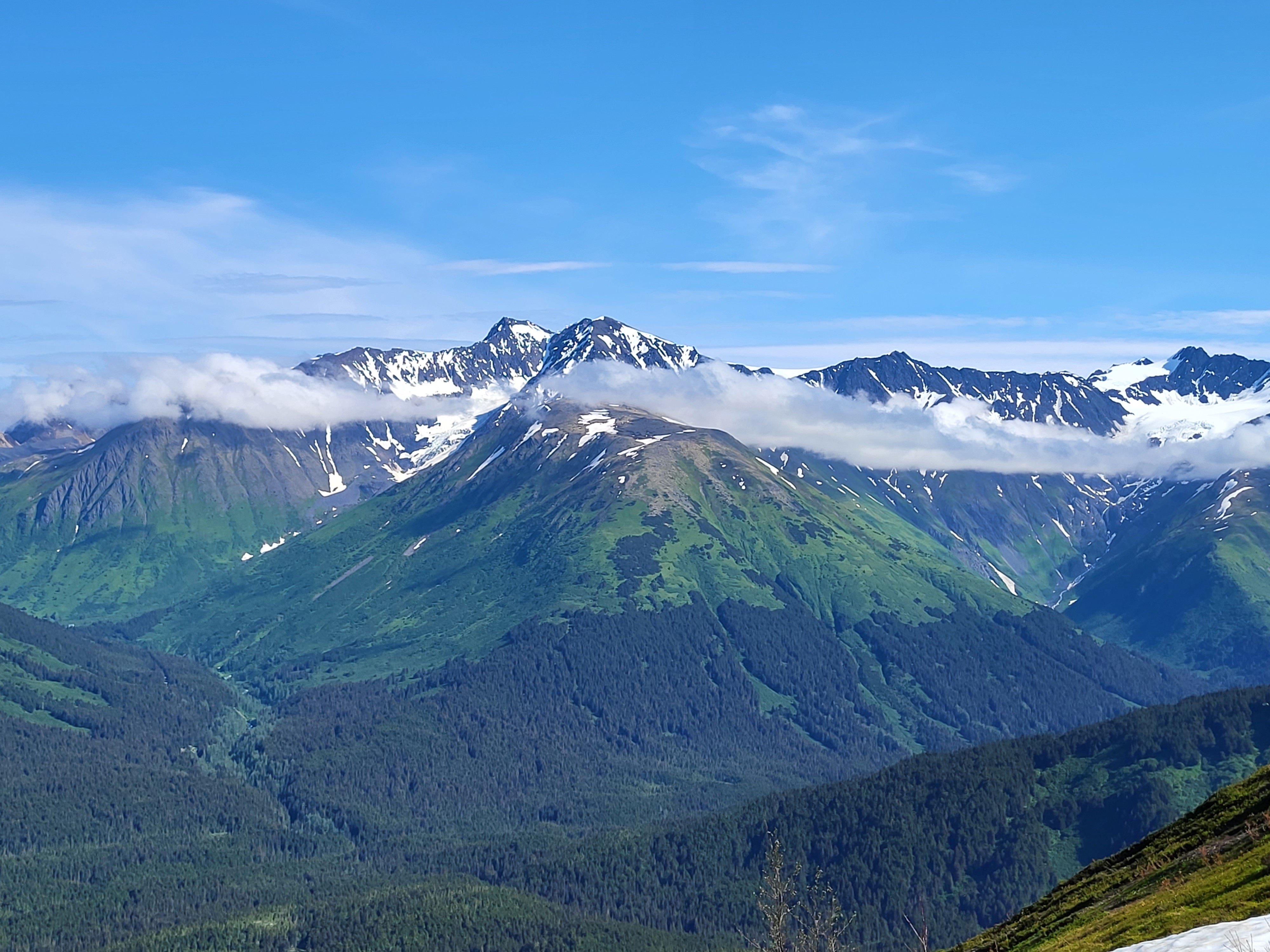 A stunning view of the majestic mountain, with snow-capped peaks and picturesque valleys, in Anchorage, Alaska.