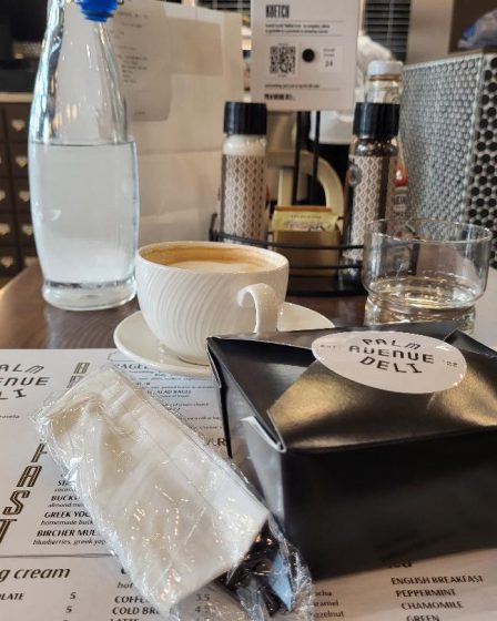 Egg sandwich from Palm Avenue Deli, served in a black box inside a white paper bag.