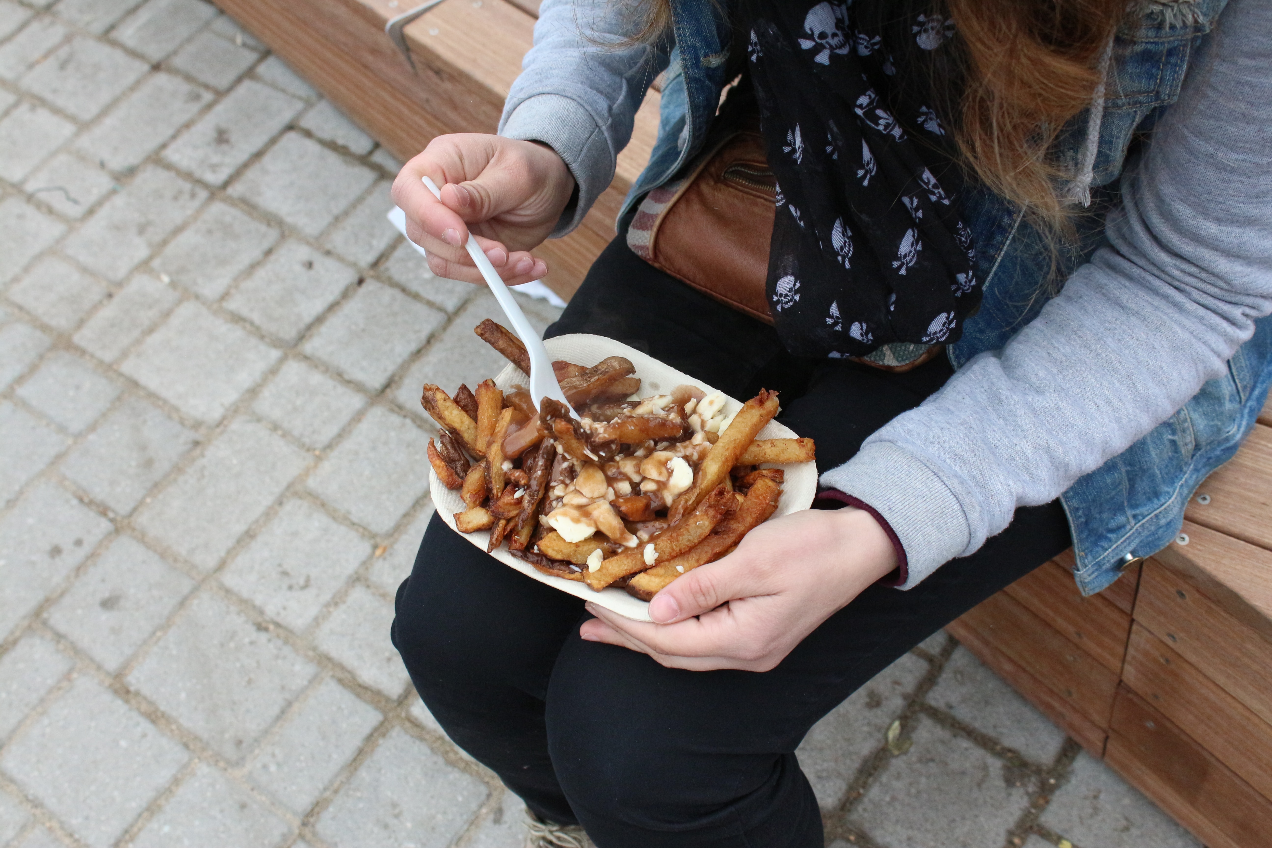 A mouthwatering image of Canadian poutine, featuring golden crispy fries topped with cheese curds and smothered in savory gravy.